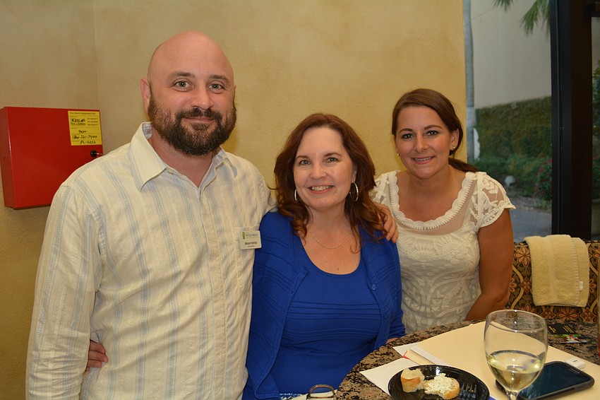 Payton Wright's Uncle Brian Porter catches up with Tammy Overgaard, of Sarasota, and his girlfriend, Christina Lubin, of Bradenton. Overgaard heads up the Payton Wright Foundation's annual golf tournament.