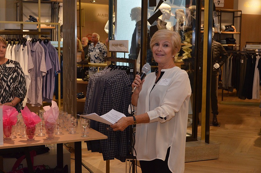 Sole Chair Ann Miller tells the crowd that these Wine Women & Shoes stemless wine glasses were made by Tervis just for the event.