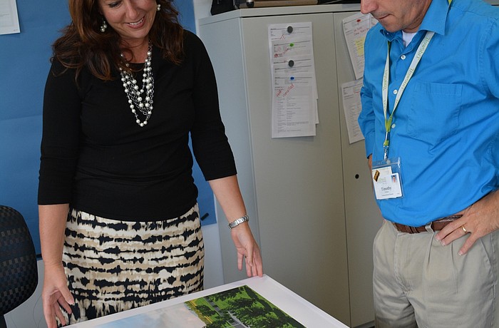 Tidewell Chief Philanthropic Officer Denise Pope and Communications Director Timothy Wolfrum look over plans for the new Lakewood Ranch Hospice House, slated for construction starting in March 2017.