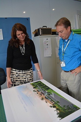 Tidewell Chief Philanthropic Officer Denise Pope and Communications Director Timothy Wolfrum look over plans for the new Lakewood Ranch Hospice House, slated for construction starting in March 2017.