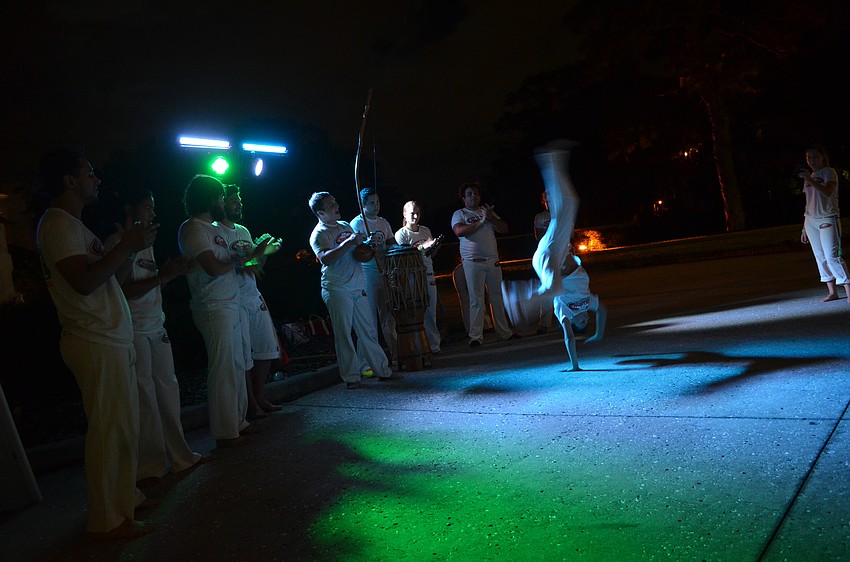 Martial artists perform as visitors enter the celebration.