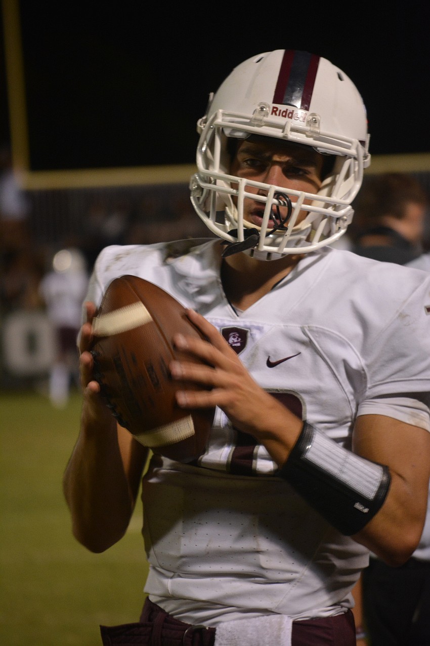 Braden River senior quarterback Louis Colosimo warms up before the second half of the Pirates' game against Venice.