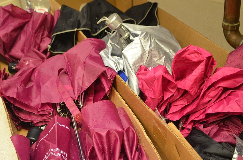 Due to rain, guests and their pets were huddled indoors for the blessing. Umbrellas piled on top of each other in the church’s kitchen.