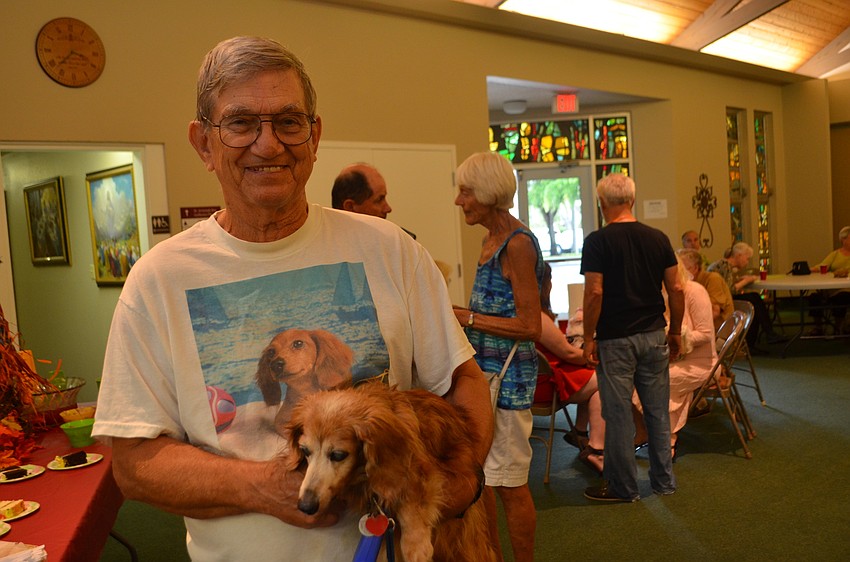 Joe Orear with Gunner, a 17-year-old long-haired miniature dachshund. Orear’s niece made the shirt he’s wearing that features a picture of Gunner as a puppy.