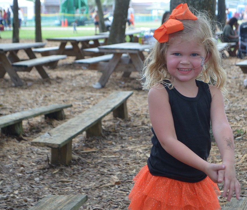 Three-year-old Olivia Doidge, of Wesley Chapel, found a good spot to dance in the amphitheatre.