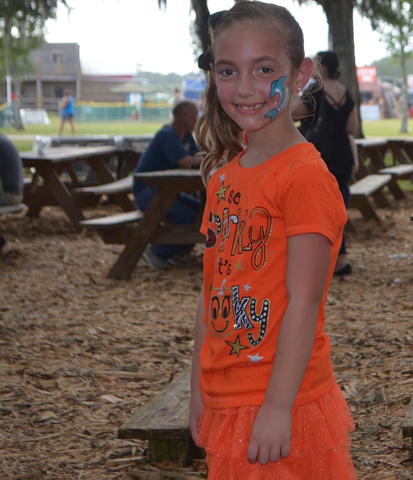 What would a festival be without face painting. Wesley Chapel 6-year-old Avery Fife shows off her art.