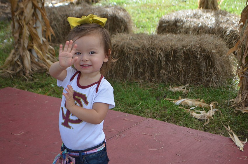 Sarasota's Jule Shirley, 1, enjoys a wave of fun at the festival.