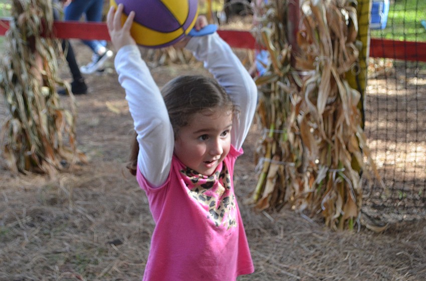Parrish 4-year-old Lily Spaulding didn't pass on the opportunity to have fun throwing a basketball.