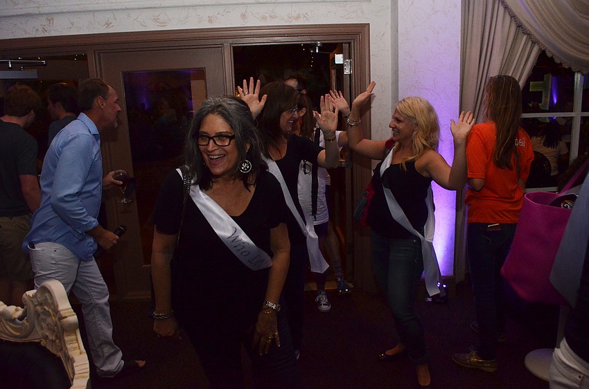 Members of Who Let the Docs Out? make an exuberant entrance to the party.