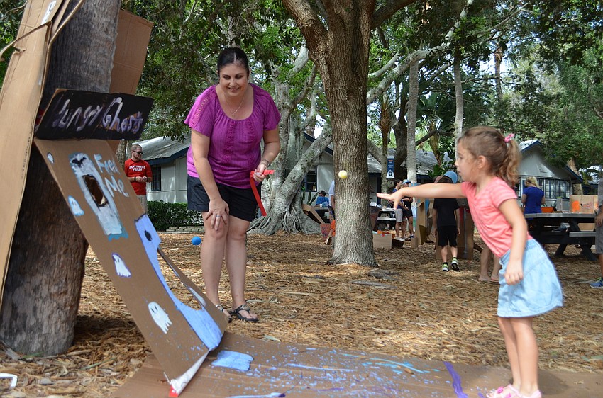 Sarasota County Commissioner Christine Robinson encourages Molly Rauch during the  Out-of-Door Academy Global Cardboard Challenge.