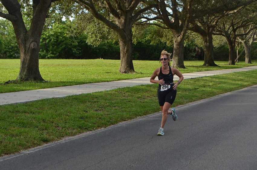 Barbara Wojdan of Clearwater, Fla., runs down Longboat Club Road during the triathlon.