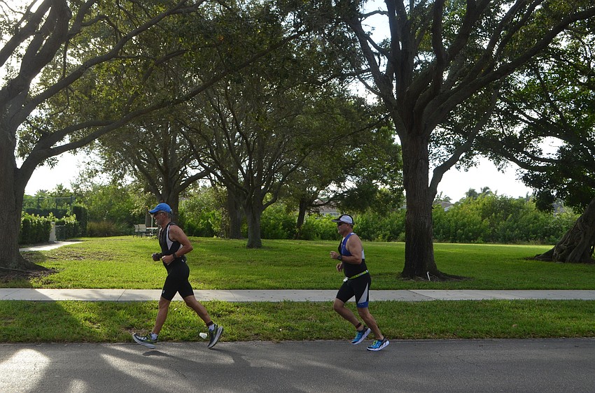 Participants race down Longboat Club Road during the triathlon.