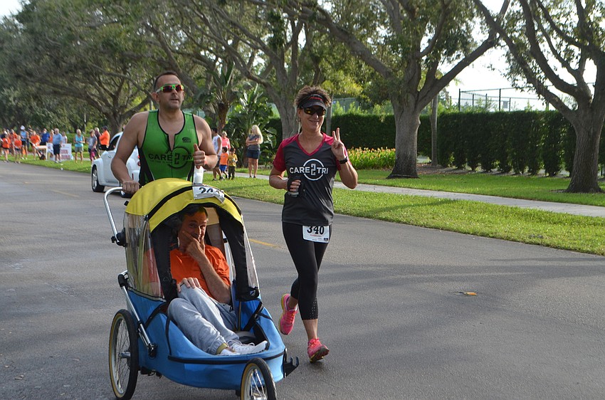 Greg Simony enjoys some company while running during the Longboat Key Triathlon.