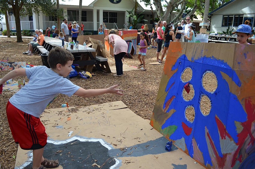 Seb takes a turn on one of the monster-themed cardboard games.