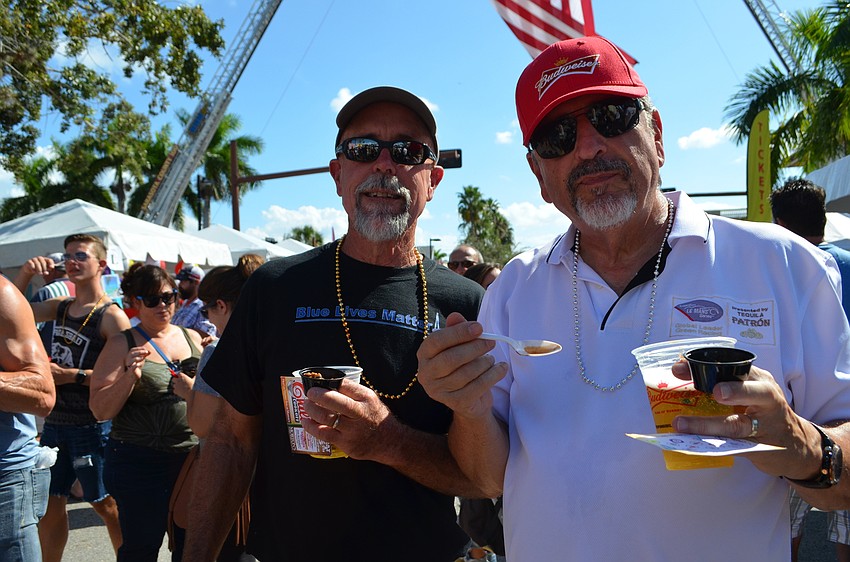 Dave White and Russ Simmons taste the chili from Station 8.