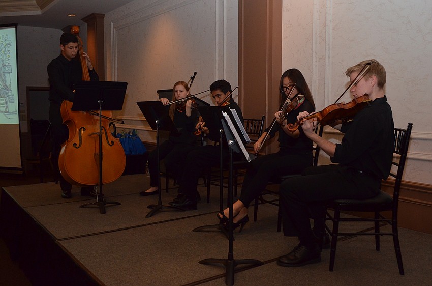 Members of The Out-of-Door Academy Advanced Chamber Ensemble perform for attendees.