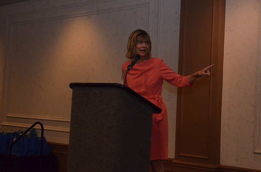 Commissioner Suzanne Atwell points to Art Center Sarasota Executive Director Lisa Berger in agreement before presenting a proclamation on behalf of the city of Sarasota.