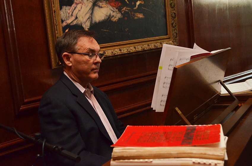 Artistic Director Joseph Holt plays the piano while Kiran Kimbell sings during a performance at Amore by Andrea.