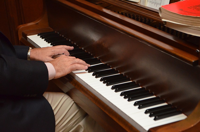 Artistic Director Joseph Holt plays the piano during a Gloria Musicae a performance at Amore by Andrea.