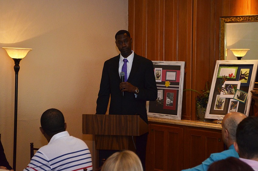 Aaron Bellamy, male engagement coordinator for SPARCC, introduces keynote speaker Mayor Willie Charles Shaw.