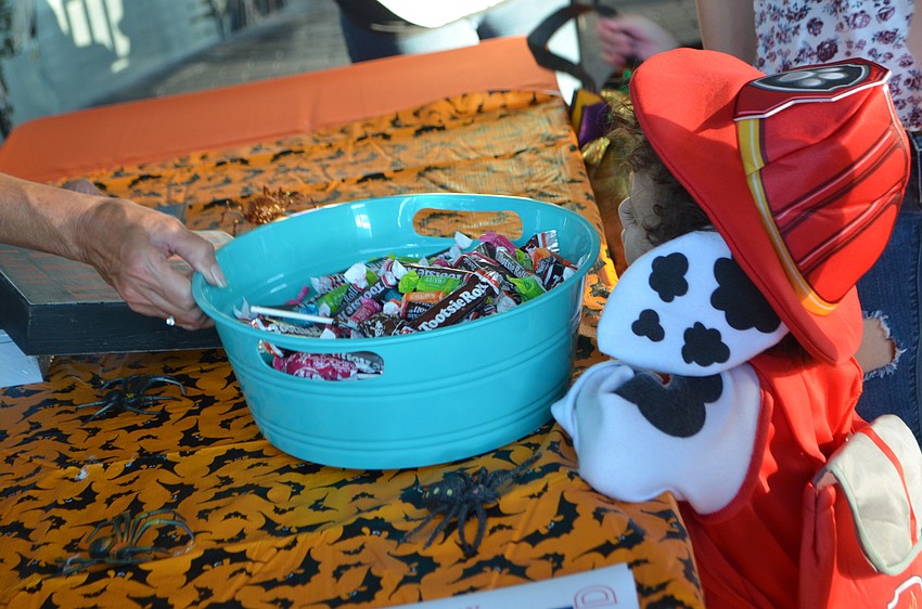 Julian Rivera 2, picks out candy at Mote’s Night of Fish, Fun and Fright.