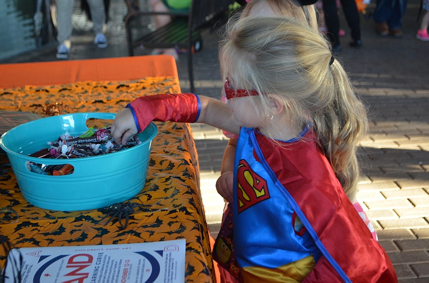 Zoe Brookshire, 4, picks out a piece of candy at Mote’s Night of Fish, Fun and Fright on Oct. 21.