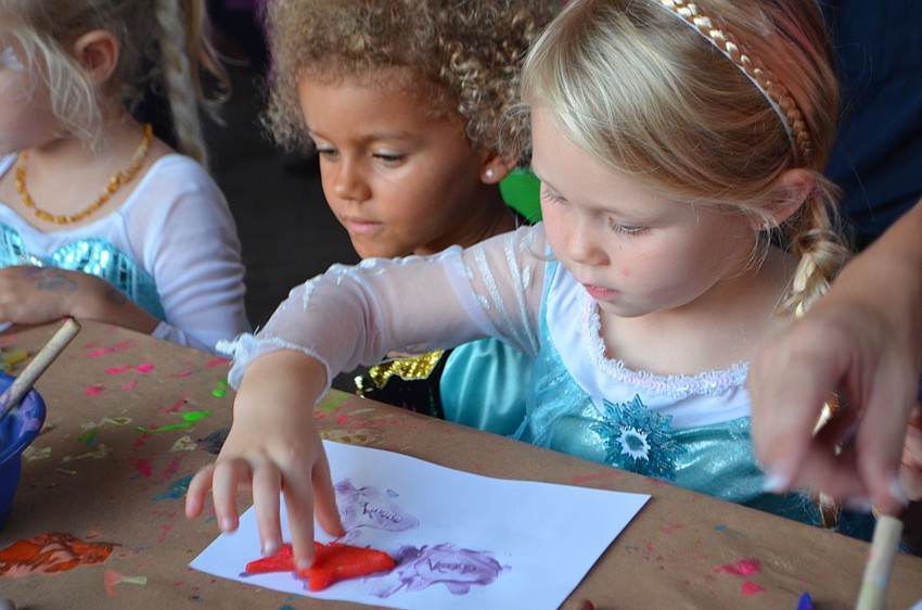 Kelsey Lodge, 3, finger paints at Mote’s Night of Fish, Fun and Fright on Oct. 21.