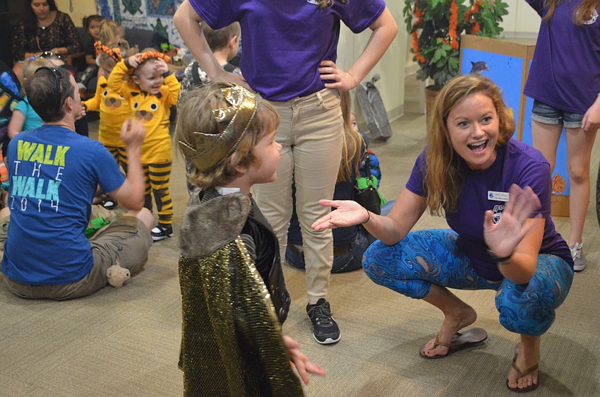 Mandy Wrobel, Senior Public Program Coordinator for Mote, greets kids as they join a Mommy and Me Session at Mote’s Night of Fish, Fun and Fright.
