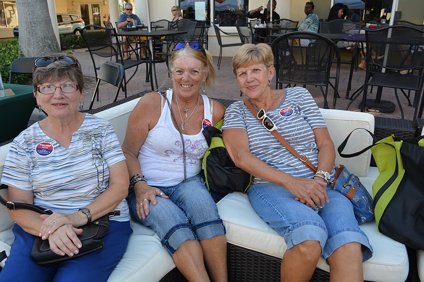 Belinda Good, Cindy Laudano and Mary Ann LaLonde, all of Bradenton, lounge on patio furniture set up on Main Street.