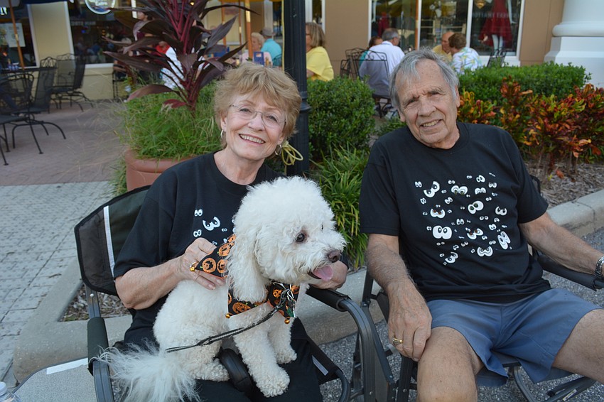 GAil and Tom Myers, of Braden Woods, find a shady spot to watch the crowds and listen to music with their dog, Taffy.
