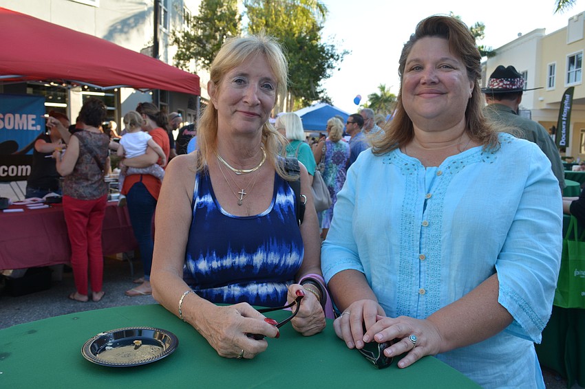 Faith Frost, of Braden Pines, and Aimee Leigh, of Gates Creek, sample food and enjoy the cooler weather at the block party.