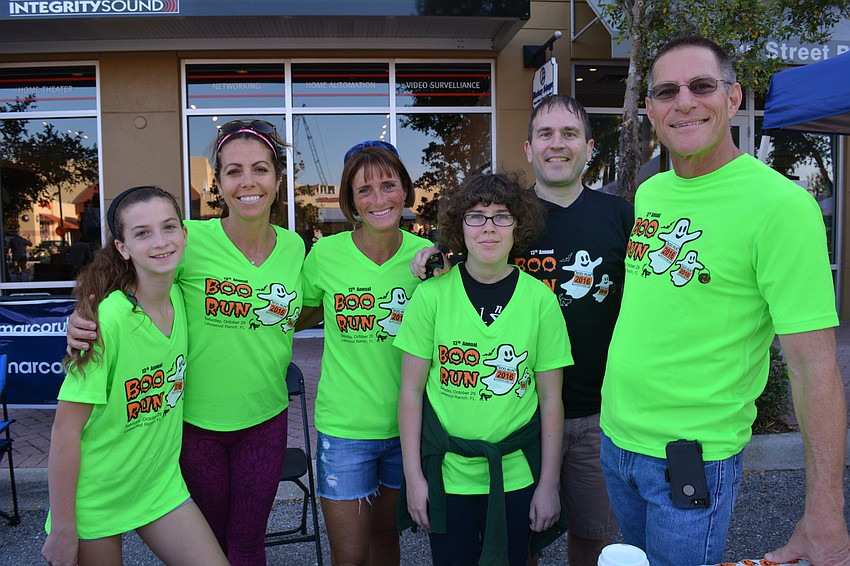 As part of Club Day, Lakewood Ranch Running Club members Summer and Andrea Rutsky, Jennifer Tullio, Adrienne and Michael Brady and Chuck Froman promote the club's upcoming Boo Fest run.