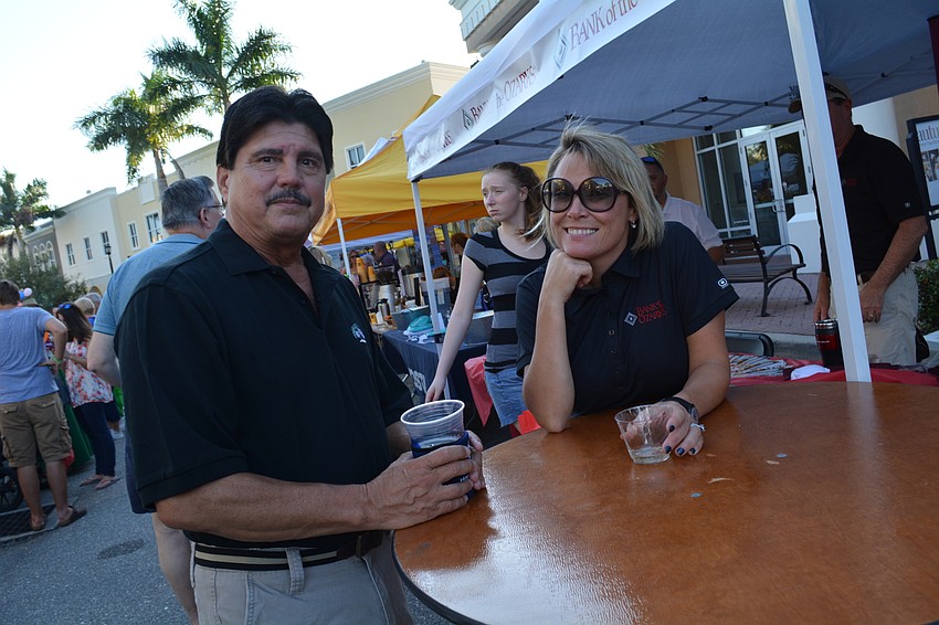 Bill Jarema, of Lakewood Ranch, catches up with Anya Keogh, of Bank of the Ozark, which had a booth at the festival.