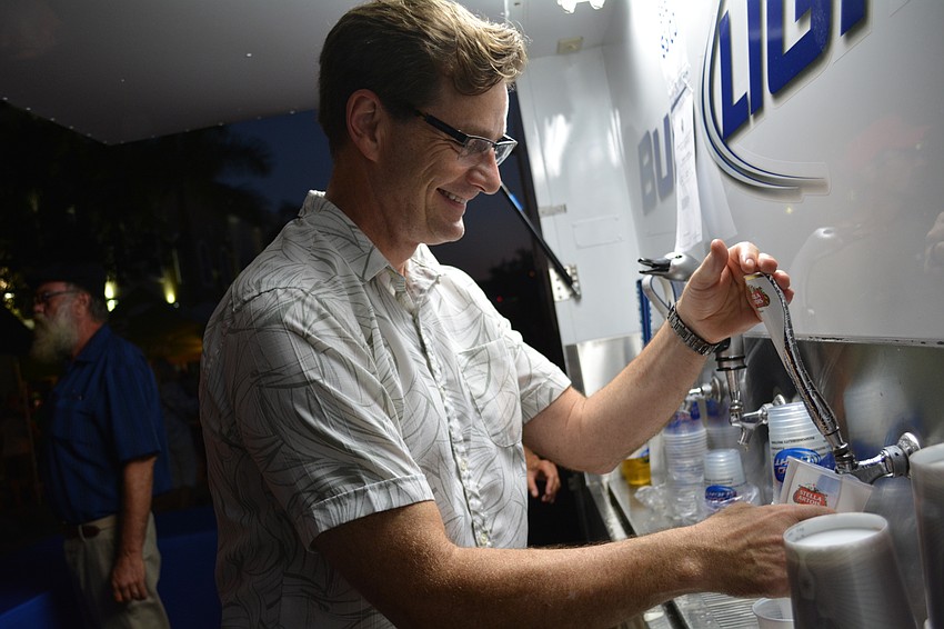 Michael Kline pours beer on tap for patrons of the event.