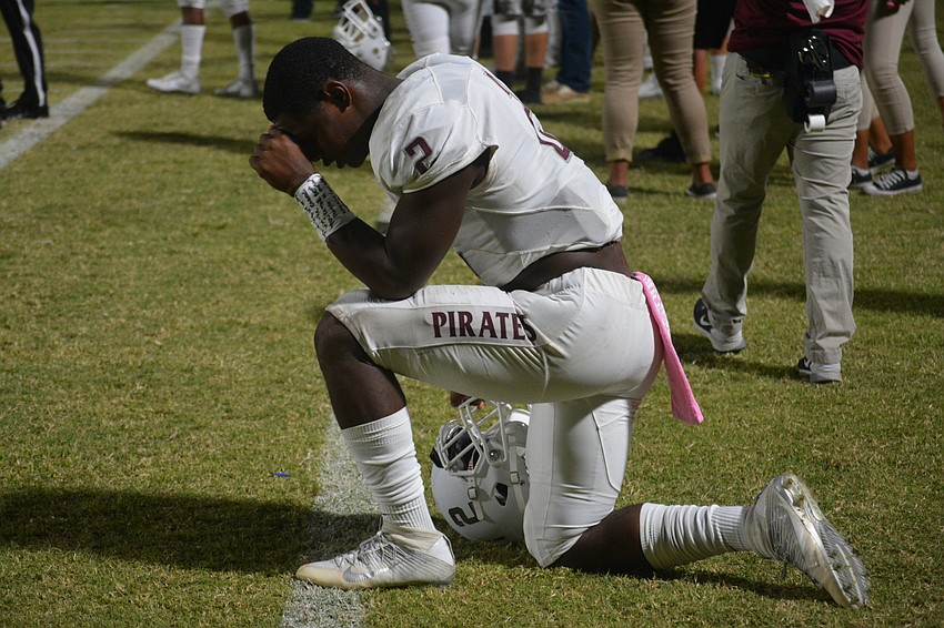 Braden River junior running back Deshaun Fenwick kneels before his team's game against Palmetto on Oct. 21. The Pirates would win the game 35-0.