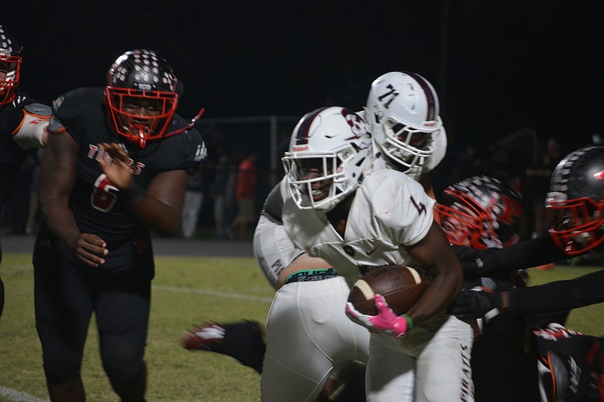 Braden River senior running back Raymond Thomas takes a handoff for a nice gain during the Pirates' 35-0 win over Palmetto on Oct. 21.