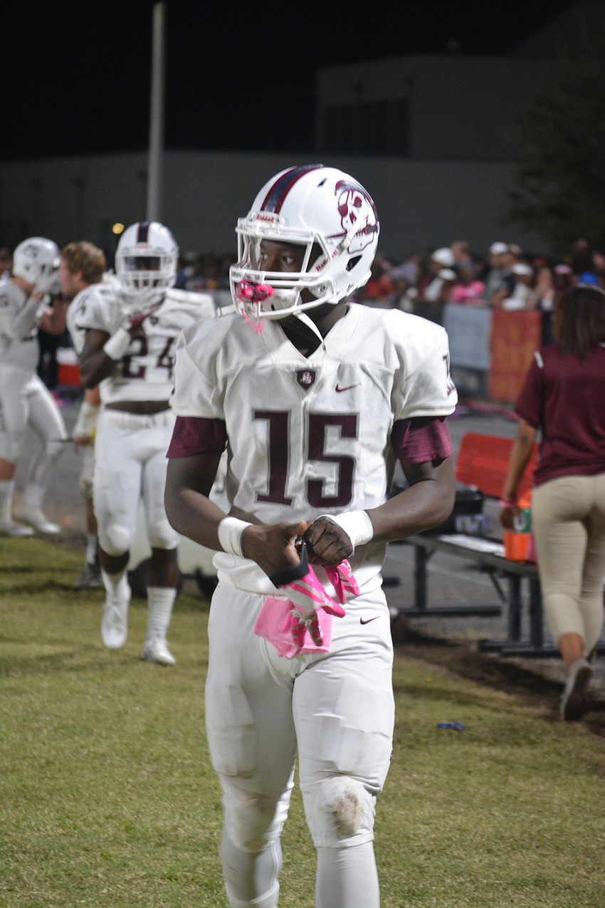 Braden River sophomore offensive weapon Knowledge McDaniel puts on his receiving gloves during the Pirates' 35-0 win over Palmetto on Oct. 21.