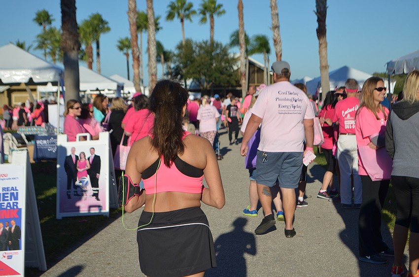 Parrish's Anita Squire, 52, soaks up some sun in the midst of the large crowd that came out for the Strides Against Breast Cancer Walk at the Sarasota Polo Club.