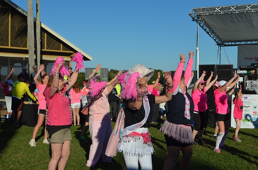 Members of Sarasota's American Cocktail Society, a non-profit organization that raises money for breast cancer awareness, dance their hearts out before the walk.