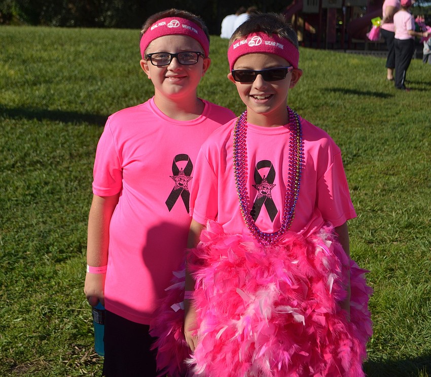 Sarasota's Aiden Zengal, 10, and Logan Tatro, 9, are in the pink after finishing the Strides Against Breast Cancer Walk.