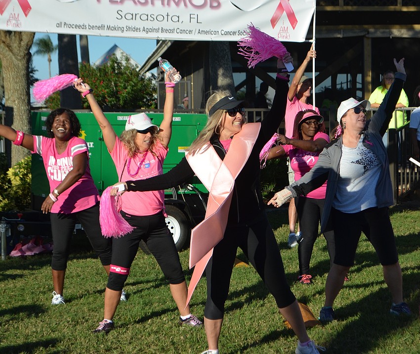 Sarasota's Kathy Schille, 51, shows off a huge, pink ribbon while she dances with the American Cocktail Society, a non-profit organization for breast cancer awareness.