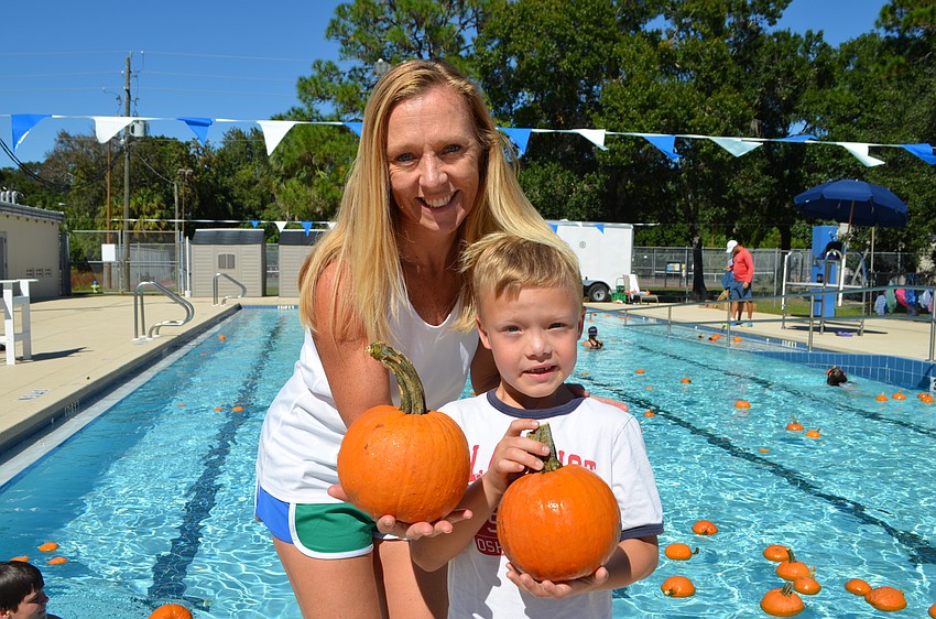 Tara and Zander Ley show off the pumpkins they picked out.