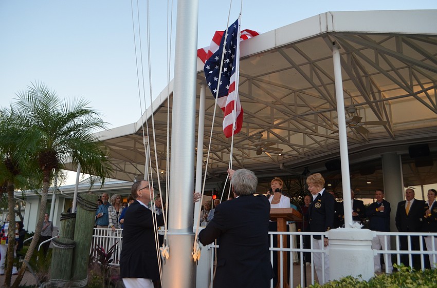 Rear Commodore Bob Williams and Vice Commodore lower the flag.