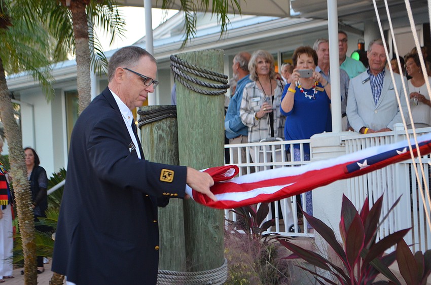 Rear Commodore Bob Williams folds the flag during Bird Key Yacht Club’s MarinaFest.