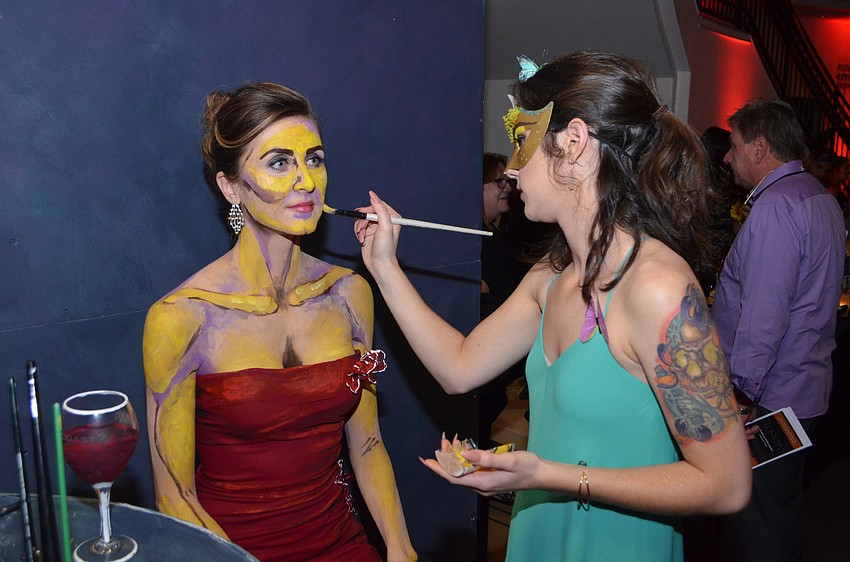 Erica Hurt does a live painting using Sharelle Romero as a canvas.