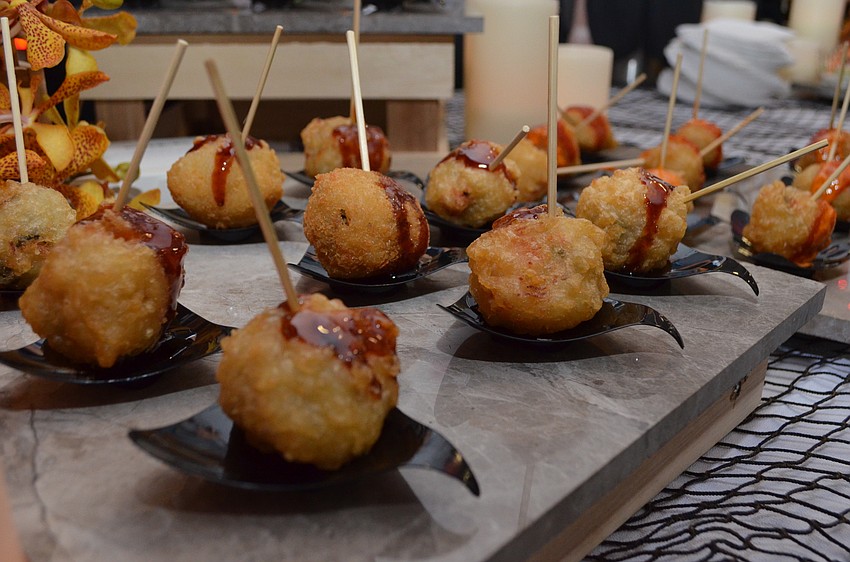 Tsunami Sushi & Hibachi Grill employees serve sushi balls made tempura style.