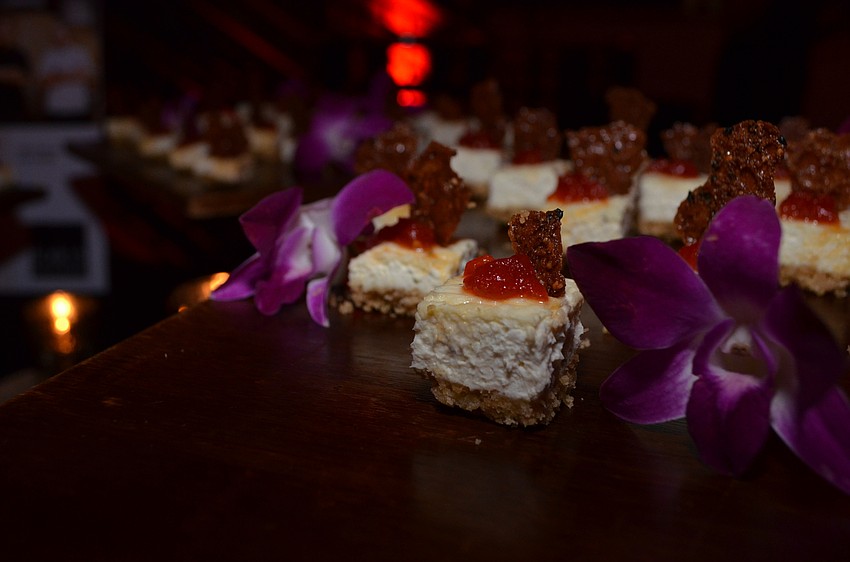 Louie’s Modern employees serve goat cheese cheesecake bites.