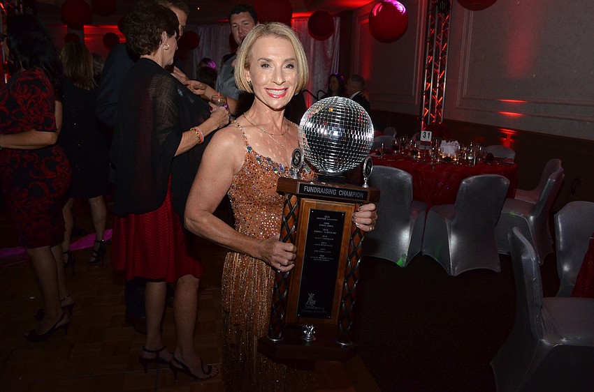 Alix Redmonde shows off her Fundraising Champion trophy.