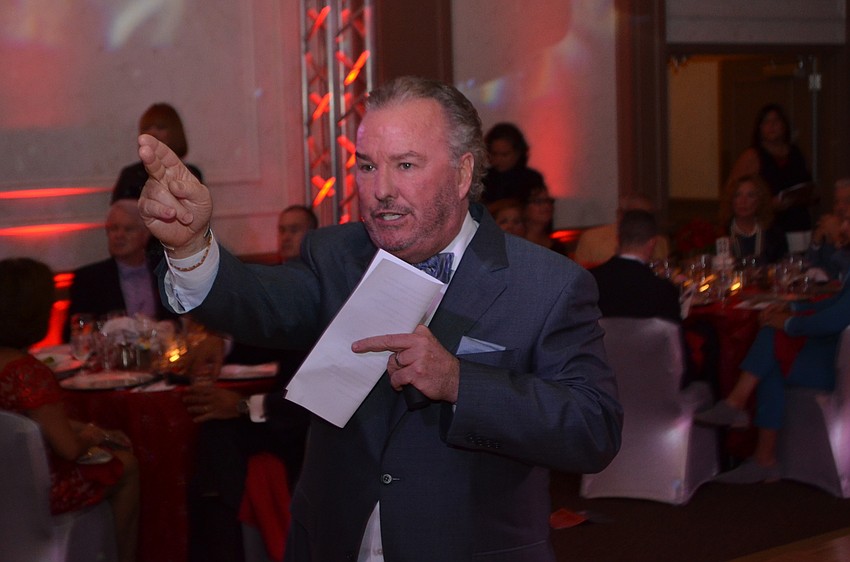 Auctioneer Michael Klauber points to a bidder during the live auction.