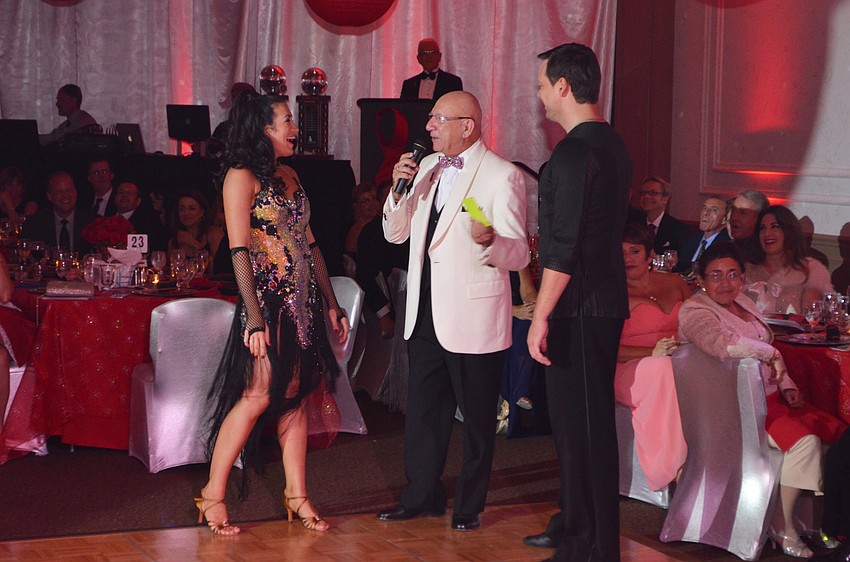 Ashley Guttridge laughs with partner Sid Pocius as Emcee Bob Nosal asks her why she’s tired after her performance.